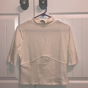 short sleeve turtle neck cream ribbed shirt.